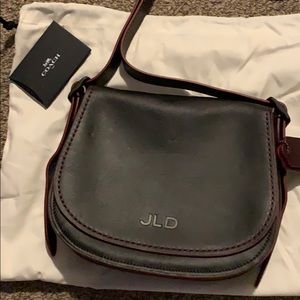Coach Saddle Bag purse never used. Black and red.